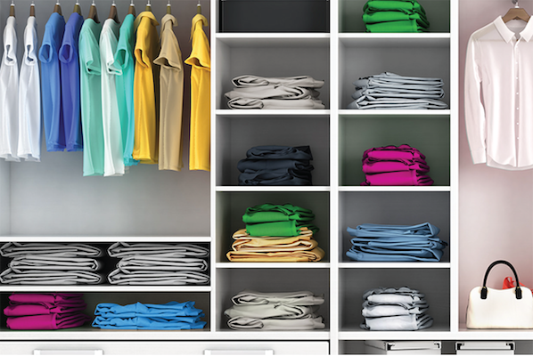 Neatly organized closet, with clothes hung and folded